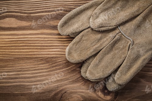 Preview: Leather Protective Gloves On Vintage Wood Board Construction Concept.