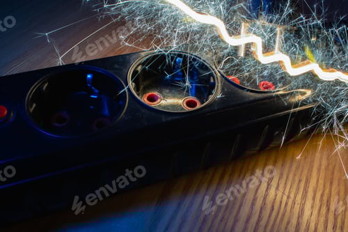 Preview: Short Circuit In Extension Socket And Plug. Low Key, Toned. The Concept Of A Domestic Fire Due To