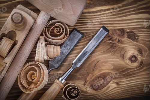 Preview: Wooden Mallet Shaving Plane Flat Chisels Curled Shavings On Vintage Wood Board Construction Concept.
