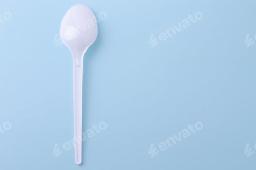Preview: Plastic Disposable Spoon On A Blue Background With Place For Text.