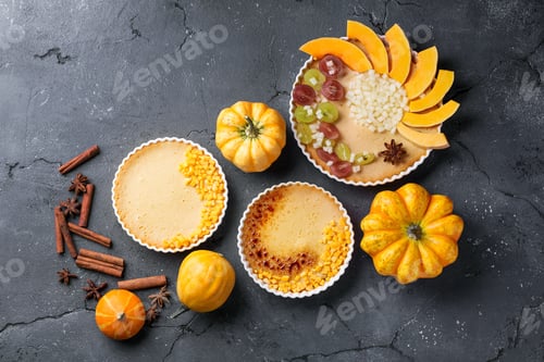 Preview: Pumpkin Cheesecake Served With Spices Sugar And Grapes Decorated With Pumpkins Over A Black Stone