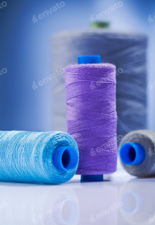 Preview: Sewing Spools On Blue Background