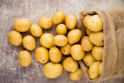 Preview: Sack Of Fresh Raw Potatoes On Wooden Background, Top View.