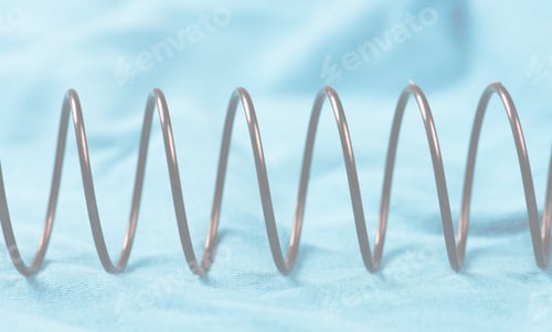 Preview: Details Of A Metal Spring On Pink Cloth.