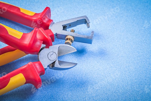 Preview: Insulated Wire Strippers Nippers On Blue Background Electricity Concept.