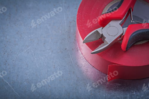 Preview: Insulating Tape Nippers On Metallic Background Construction Concept.