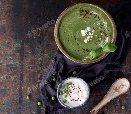 Preview: Home Made Pea Soup Served With Yogurt, Chili And Feta Cheese. Top View
