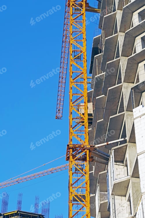 Preview: Building Crane And Building Under Construction Against Blue Sky