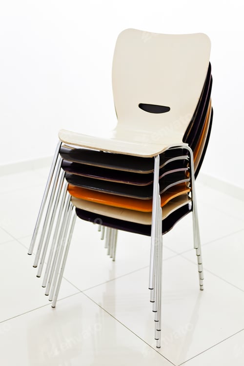 Preview: Stacked Plastic Chairs In White Room, Side View