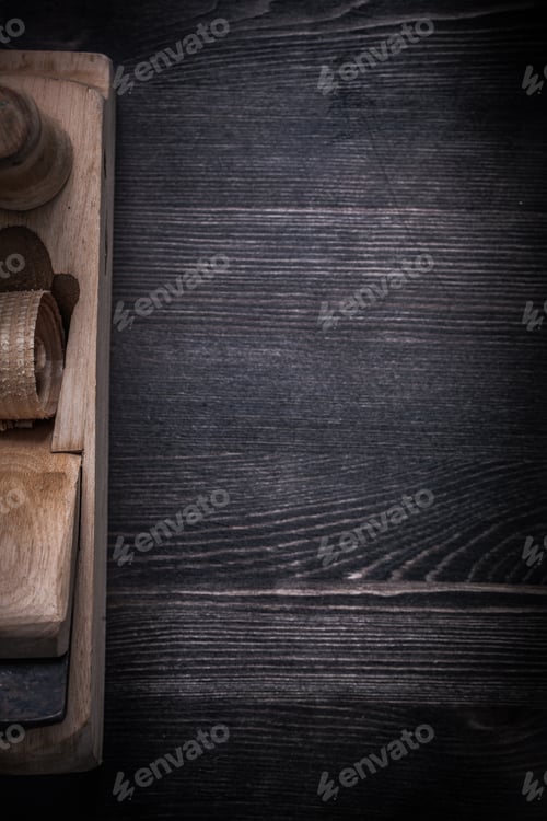 Preview: Wooden Shaving Plane On Wood Board Copyspace Construction Concept.