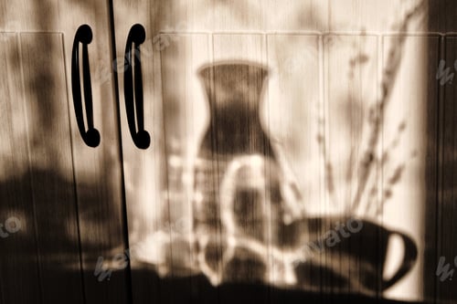 Preview: Shadow Dishes On The Kitchen. Shadows On Wooden Background In Kitchen. Cup And A Decanter Of Water