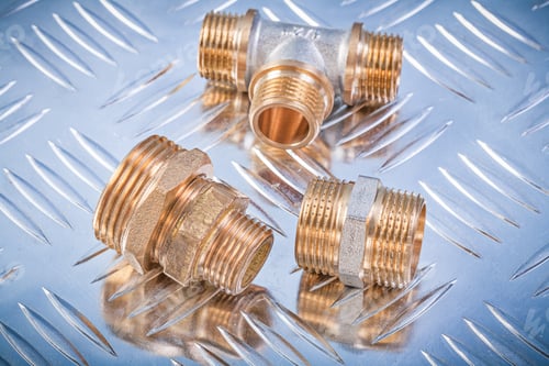 Preview: Brass Hose Nipples Equal Tee On Grooved Metal Background Plumbing Concept.