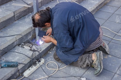 Preview: Construction Worker Welding a Metal Post