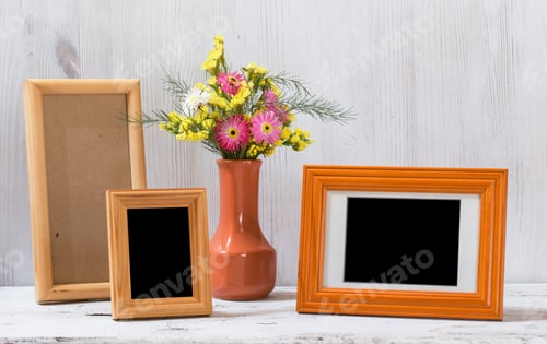 Preview: Photo Frames And Flowers On Old White Table