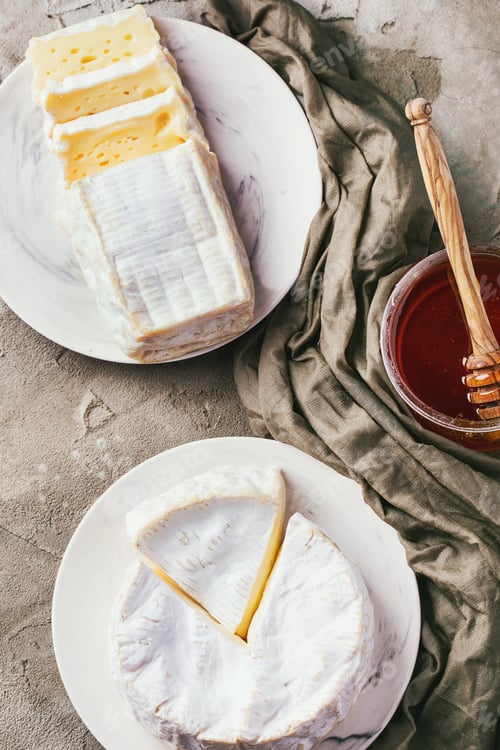 Preview: Assortment Of French Cheese Served With Grapes And Honey Decorated With Napkin. Top View