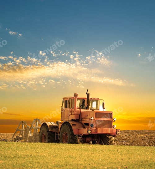Preview: Tractor Cultivating The Field On Sunrise