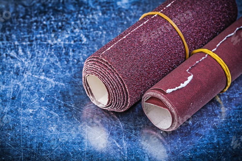 Preview: Rolls Of Emery Paper On Metallic Background Abrasive Equipment.