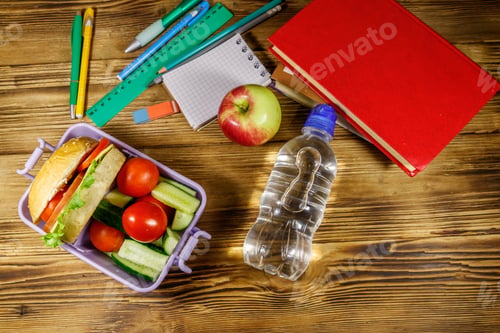 Preview: Back To School Concept. School Supplies, Books, Bottle Of Water, Apple And Lunch Box With Burgers