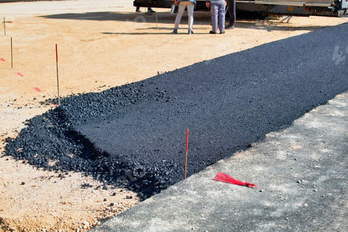 Preview: Laying Fresh Asphalt On The Road. Construction Of The Road, Gravel Base. Selective Focus.
