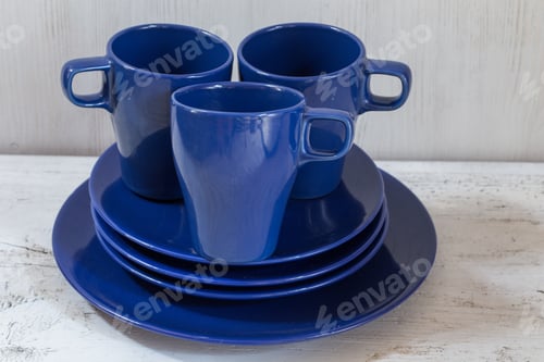Preview: Mugs And Plates On Old White Table