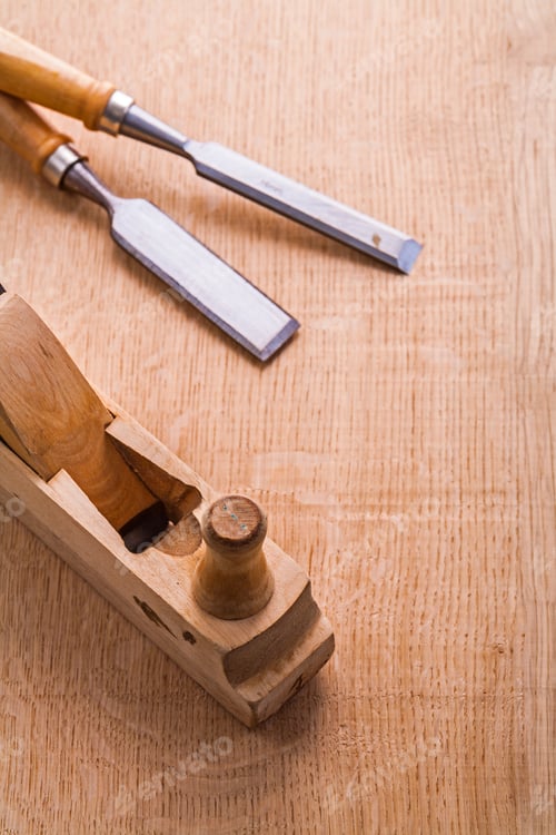 Preview: Old Woodworkers Plane And Carpentry Chisel On Wooden Board