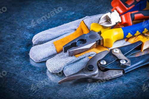Preview: Safety Gloves With Nippers Pliers And Tin Snips On Scratched Vintage Metallic Background