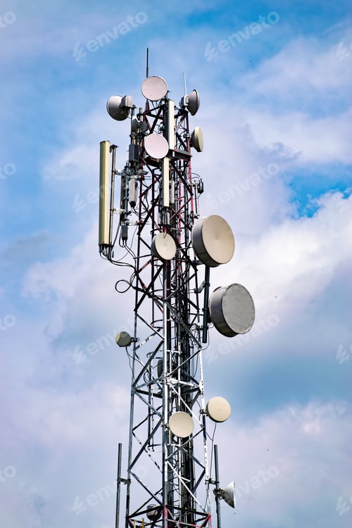 Preview: Telecom Tower With Lots Of Aerials And Antennas Mounted On It Against Cloudy Sky Background