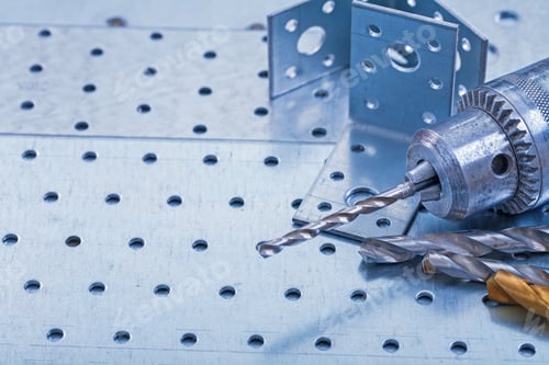 Preview: Drill With Boring Bits And Angle Bars On Perforated Metallic Background Construction Concept.