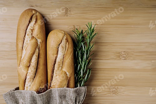Preview: Traditional French Baguette Wrapped In Recycled Bag Decorated With Rosemary. Sustainable Package