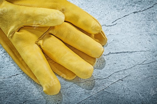 Preview: Leather Protective Gloves On Metallic Background Construction Concept.