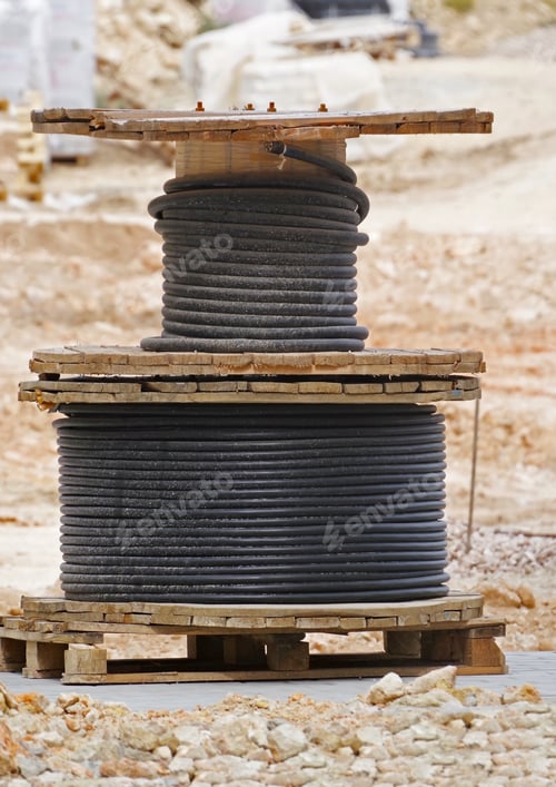 Preview: Black Wire Electric Cable With Wooden Coil Of Electric Cable On Construction Sites