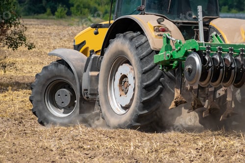 Preview: Yellow Tractor With The Cultivator Turning Around On The Field