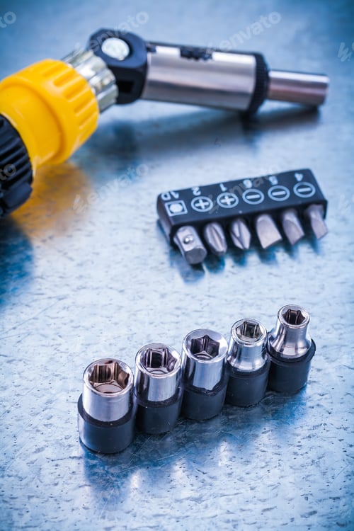 Preview: Vertical Version Of Reversive Turnscrew Screwdriver Bits And Torx On Metallic Background