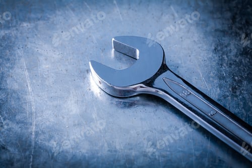 Preview: Stainless Spanner Wrench On Scratched Metallic Background Close Up View Construction Concept.