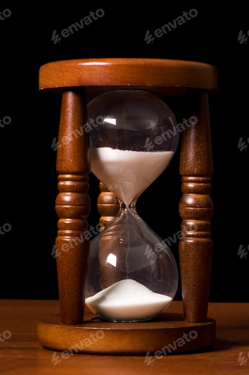Preview: Hourglasses On A Wooden Table