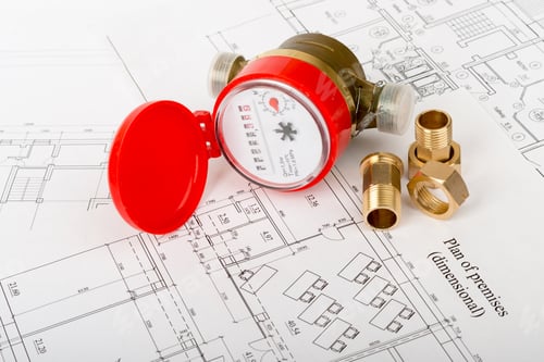 Preview: Red Water Meter With Fitting Pieces On Draft Background