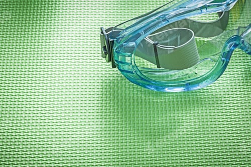 Preview: Protective Glasses On Green Background Construction Concept.