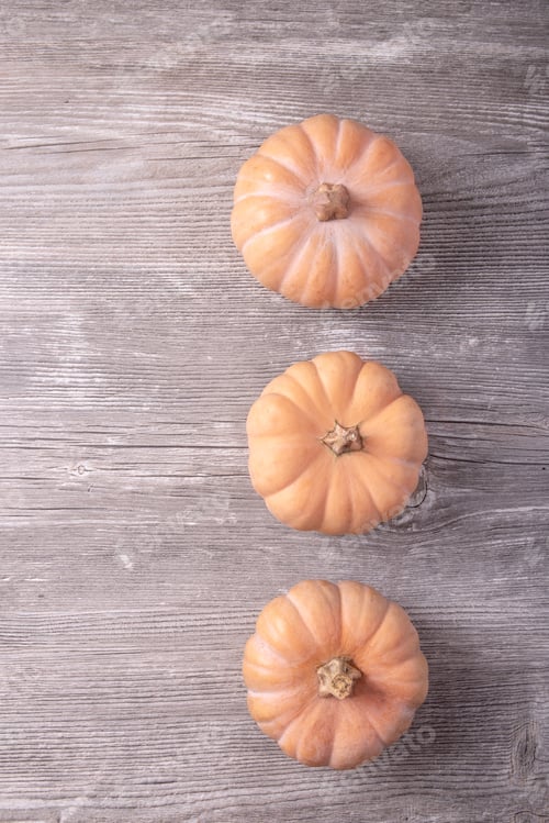 Preview: Decorative Pumpkins Over The Grey Wooden Background. Top View
