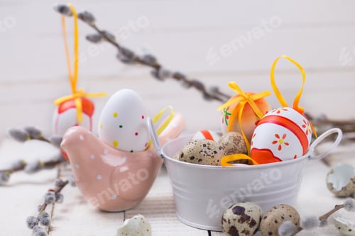Preview: Colorful Easter Eggs In Bucket, Decorative Bird And Willow Branches On Wooden Background. Easter