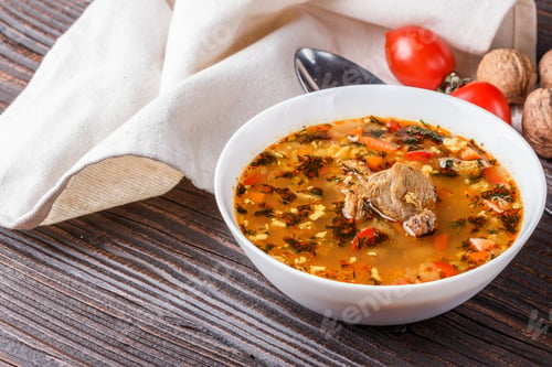 Preview: Georgian Soup. Kharcho With Rice, Tomato, Beef, Garlic And Herbs In Bowl On Wooden Table