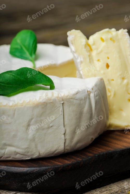Preview: French Cheese - Round Camembert With Basil Leaves On A Wooden Background