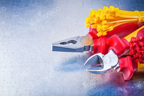 Preview: Composition Of Nippers Pliers Tying Cables On Scratched Metallic Background.