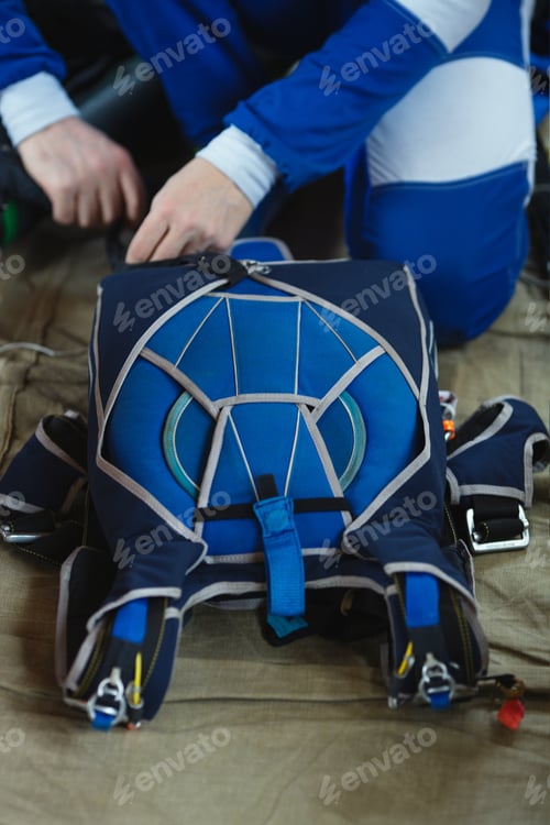 Preview: Packed Parachute And The Skydiver'S Hands Are Close-Up, The Face Is Not Visible. Parachute