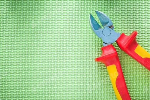 Preview: Insulation Nippers On Green Background Electricity Concept.