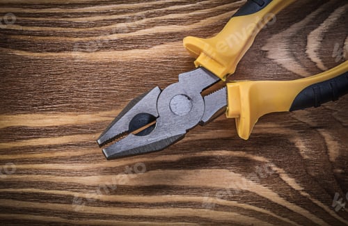 Preview: Pliers On Vintage Wooden Board Directly Above Construction Concept.