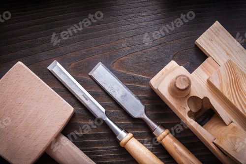 Preview: Lump Hammer Planer Flat Chisels And Wooden Bricks On Brown Background Construction Concept.