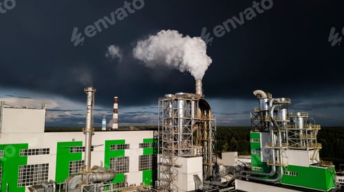 Preview: White Smoke From Factory Chimneys Against A Dark Sky