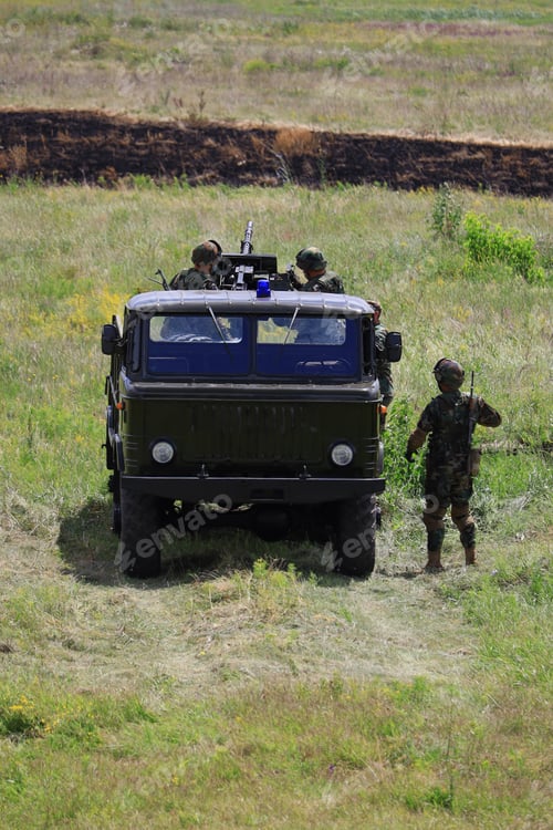 Preview: Heavy Armored Military Police Truck In A Green Field.