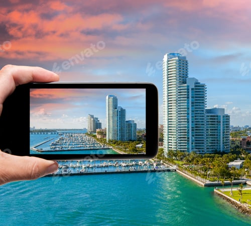 Preview: Male Hand With Smartphone Taking A Picture Of Miami From Cruise Ship. Tourism Concept.
