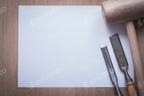 Preview: Firmer Chisels Lump Hammer And Clean Sheet Of Paper On Wooden Board Copy Space Construction Concept.